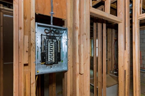 New electrical panel installed in open wall framing